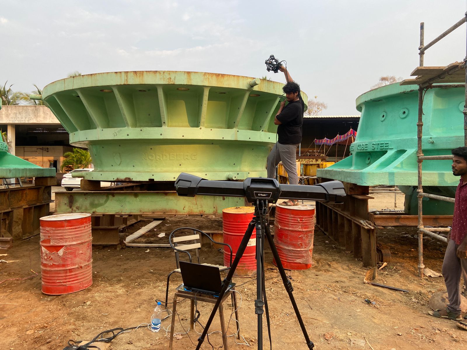 A picture of a technician using the MetraSCAN BLACK+™|Elite to scan a large part located outdoors.